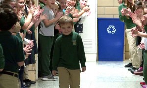 A little boy who beat cancer gets a warm welcome from his entire school