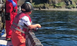 Excited Three-Year-Old Catches a Fish