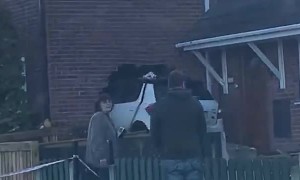 Car Stuck in the Side of a House