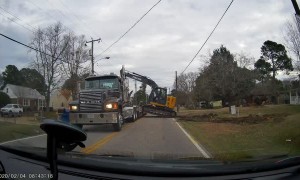 Awkward Excavator Loading Attempt Ends in Fall