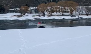 Boat Slides Through Snow Between Lakes