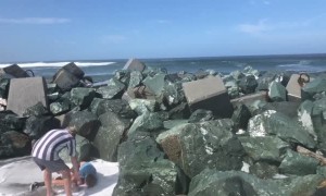 Kid Gets Swept off His Feet by Ocean