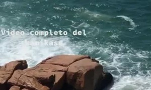 Man Hides Behind Rocks as Waves Come
