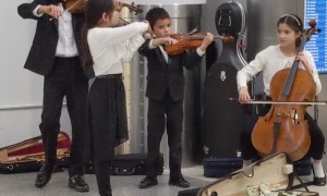 Talented Young Orchestra Playing in Lobby
