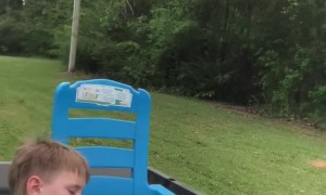 Tuckered Toddler Nods Off during Lawnmower Ride
