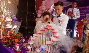 Groom Sends Champagne Cork Into Bride's Face