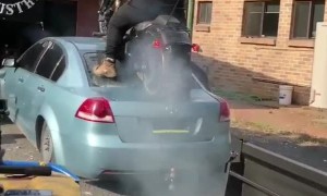 Biker Does Burnout on Back of Car