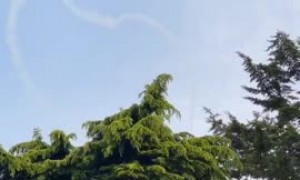 Plane paints love hearts in the sky