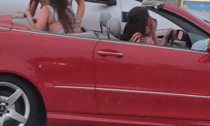 Girls Jam While Convertible Gets Soaked by Rainstorm