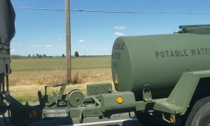 Military Vehicle Leaking Liquid Down the Highway
