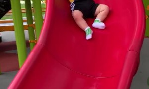 Baby Slips Slowly Down Slide