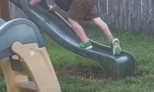 Kid Tries Climbing up Wet Slide