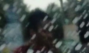 Motorcyclists Hiding From Rain Behind a Truck