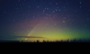 Comet Drifts Though Northern Lights