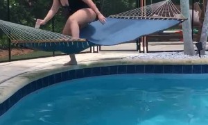Woman Trying to Relax Flips in Poolside Hammock