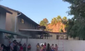 Girl Jumping into Pool From Roof Falls Short