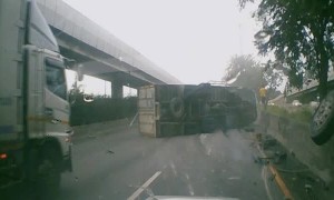 Truck Topples Over After Colliding With Barrier