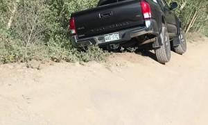 Car Hangs Precariously off Mountain Trail