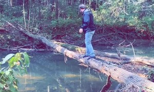 Walking Over a Fallen Tree to Cross the River