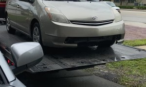 Tow Truck Driver Send Car Rolling Into Garage Door