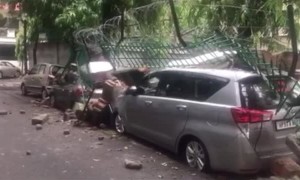 School Walls Crippled by Heavy Rains Crush Parked Cars