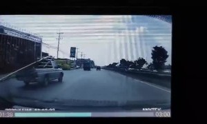 Truck Crossing Lanes with Fence Sticking Out of Truck Bed