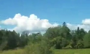 SUV Veers Off Road into Hay Trailer