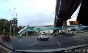 Vehicle Swerves into Car and Forces it onto Barricade
