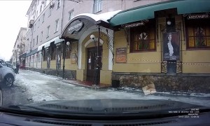 Person Walking on Sidewalk Has Close Call with Falling Snow