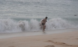 Man Runs Away While Woman Gets Hit By Wave