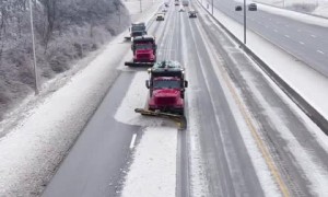 Snow fighters use synchronized snow plowing technique to clear highway