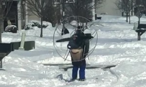 Heavy snow no match for guy wearing skis and high powered fan