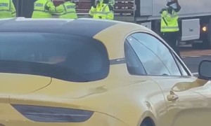 Police Escort People Out of Truck's Trailer