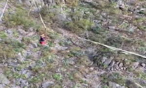 Talented Dude Catches Football while Balancing on High Slackline
