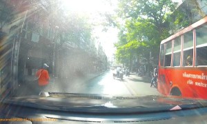 Motorist Has Close Call with Oncoming Bus