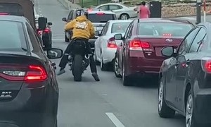 Angry Motorcyclist Kicks Swerving Car