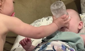 Big Sister Sends Bottle at Baby