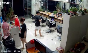 Guy and Gal Tumble over Barbershop Cabinet