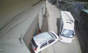 Runaway Truck Pushes Parked Car Into Building