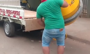 Man Loads Concrete Mixer into a Truck by Himself