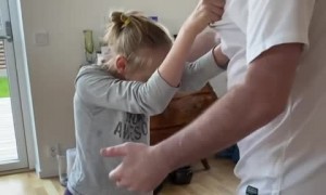 Girl with brain disease incredibly dances hands-free with her dad