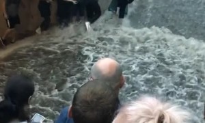 Passengers Flee as Flooding Flows Down Metro Stairs