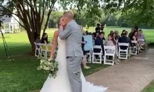 Newlywed couple falls after attempting a romantic kiss  