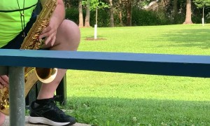 Squirrel Enjoys Listening to the Saxophone at the Park