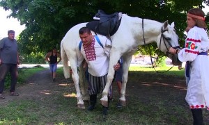 Strong Man Walks Carrying a Horse
