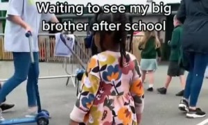 Little girl preciously hugs her big brother after school