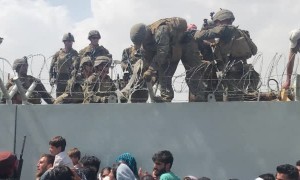 Afghan Infant Passed to Soldiers at Airport