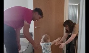 Excited Parents Encourage Son's First Steps