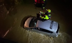 Firefighters Rescue Man Trapped in Car During Flood