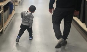 Little Boy Practices Walking Like Dad